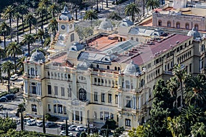 Aerial view of a yellow building surrounded by palm trees