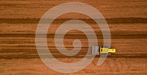 Aerial view yellow excavator building a highway, Road grader heavy earth moving, Bulldozer working at road construction