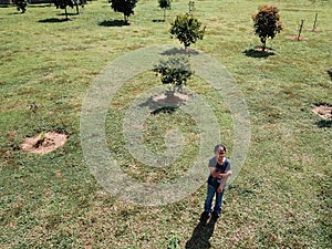 Aerial view of a young asian girl wearing glasses standing in the park.