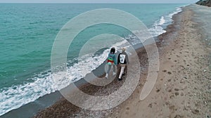 Aerial view of young couple walk on beach