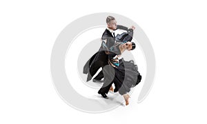 Aerial view of young graceful artistic couple, man and woman dancing waltz isolated over white studio background