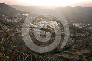 Aerial view of Yuanyang rice terraces filled with water in Yunnan - China, Unesco World Heritage Site