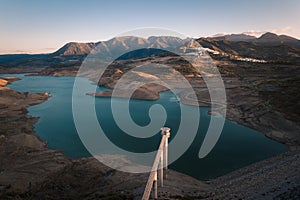 Aerial view of Zahara de la Sierra, with lake and tower in foreground at dusk, Cadiz, Spain