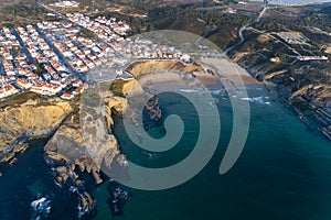 Aerial view of the Zambujeira do Mar village and beach at sunset, in Alentejo photo