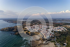 Aerial view of the Zambujeira do Mar village and beach at sunset, in Alentejo photo