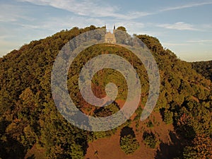 Aerial view of Zeil Chapel in the Bavarian countryside, surrounded by lush trees in the sunlight photo