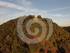 Aerial view of Zeil Chapel in the Bavarian countryside, surrounded by lush trees in the sunlight photo