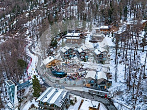 Aerial View on Zermatt Valley and luxury hotel with people partying