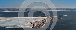 Aerial view of ÃËresund Oresund Bridge toward Sweden, during a winterly day with parts of baltic sea frozen photo