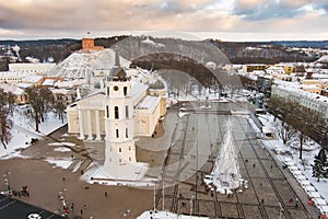 Aerial Vilnius city panorama in winter with snow covered houses, churches and streets. Cathedral square and Christmas tree. Winter