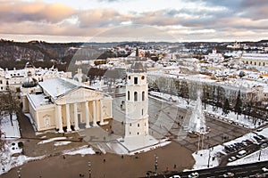 Aerial Vilnius city panorama in winter with snow covered houses, churches and streets. Cathedral square and Christmas tree. Winter