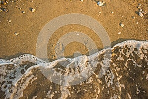 Aerial wallpaper background concept photography of washed away human foot prints from sand shoreline surface by fuzzy waves, sea