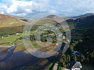 Aerial of the water, buildings and mountains in the Isle of Arran, Scotland.