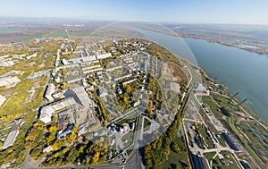Aerial water power plant view with crossroads and roads, civil buildings.