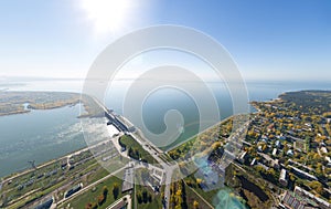 Aerial water power plant view with crossroads and roads, civil buildings.