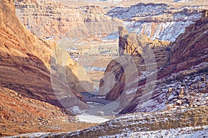 AERIAL: White lorry drives along an asphalt road winding through the canyon