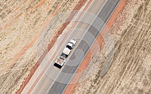 Aerial of white pickup truck on country road
