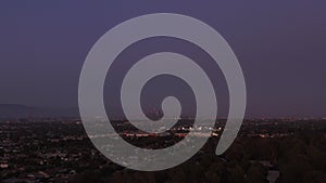 AERIAL: Wide view of Downtown Los Angeles, California Skyline from Culver City at Dusk, Night with Purple Sky