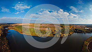 Aerial wide view of lake at sunrise in autumn. Meadows, orange grass. Colorful landscape of river sunset. Horodok Ukraine