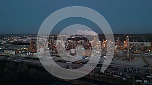 Aerial wide view of Oil and gas petrol fuel chemical tank with oil refinery petrochemical plant at twilight,