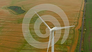 Aerial: wind turbine rotating by the force of the wind and generating renewable energy in a green ecologic way for the