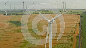 Aerial: wind turbine rotating by the force of the wind and generating renewable energy in a green ecologic way for the