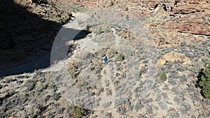 Aerial Woman hike desert mountain Nine Mile Canyon Utah 4K