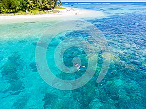 Aerial woman snorkeling on coral reef tropical caribbean sea, turquoise blue water. Indonesia Banyak Islands Sumatra, tourist