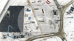 Aerial Work of a building crane, a view from above. Cement filling with a special crane. Winter construction