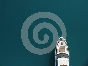 Aerial yacht on calm sea. Luxury cruise trip. View from above of white boat on deep blue water. Aerial top down view of