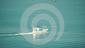 Aerial yacht on calm sea. Luxury cruise trip. View from above of white boat on deep blue water. Aerial top down view of