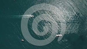 Aerial yacht on calm sea. Luxury cruise trip. View from above of white boat on deep blue water. Aerial view of rich