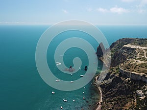 Aerial yacht on calm sea. Luxury cruise trip. View from above of white boat on deep blue water. Aerial view of rich