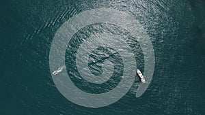 Aerial yacht on calm sea. Luxury cruise trip. View from above of white boat on deep blue water. Aerial view of rich