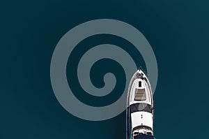 Aerial yacht on calm sea. Luxury cruise trip. View from above of white boat on deep blue water. Aerial view of rich