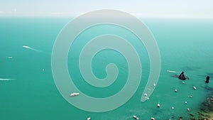 Aerial yacht on calm sea. Luxury cruise trip. View from above of white boat on deep blue water. Aerial view of rich