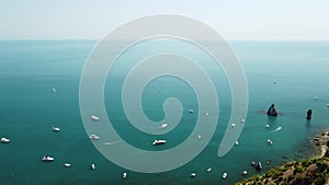 Aerial yacht on calm sea. Luxury cruise trip. View from above of white boats on deep blue water. Aerial view of rich