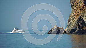 Aerial yacht on calm sea. Luxury cruise trip. View of white boat on deep blue water. Aerial view of rich yacht sailing