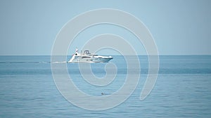 Aerial yacht on calm sea. Luxury cruise trip. View of white boat on deep blue water. Aerial view of rich yacht sailing