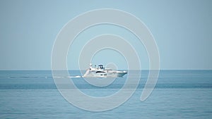 Aerial yacht on calm sea. Luxury cruise trip. View of white boat on deep blue water. Aerial view of rich yacht sailing