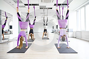 Aerial yoga class, hanging on hammocks