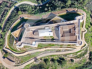 Aerial zenith plane of San Marcos Castle in a mountain of Sanlucar de Guadiana village in Huelva province, Andalusia,