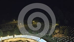 Aerial zoom out of the Srebrenica Memorial Cemetery at night