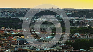 Aerial zoomed footage of famous ancient Colosseum amphitheatre and surrounding buildings at dusk. Rome, Italy