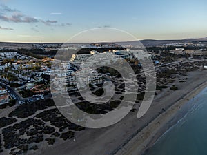 Aeriav view on sandy dunes, beach and Costa Calma, Fuerteventura, Canary islands, Spain in winter on sunset