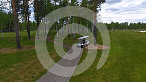 Aeriel view on Golf cart on golf course in the afternoon with copy space. Elite golf club.