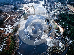 aero drone view of a flooded river during winter, showcasing the powerful and destructive forces of nature