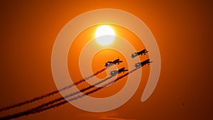 Aerobatic air plane on blue sky, aerobatic pilots on sunset