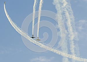Aerobatic pilots with her colored airplanes training in the blue sky