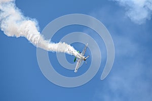 Aerobatic plane on display , Jurgis Kairys aerobatic pilot flying on blue sky